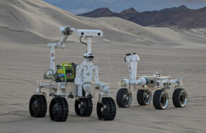 Two variations of GITAI's Lunar Rovers in a desert.