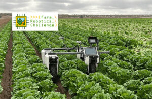 一个Farm-ng Amiga农业机器人动作通过h a field of leafy greens.